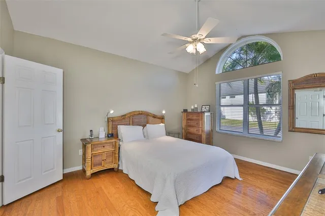 a bedroom with a large bed and a chandelier