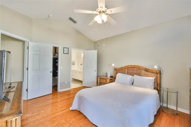 a bedroom with a large bed and a chandelier