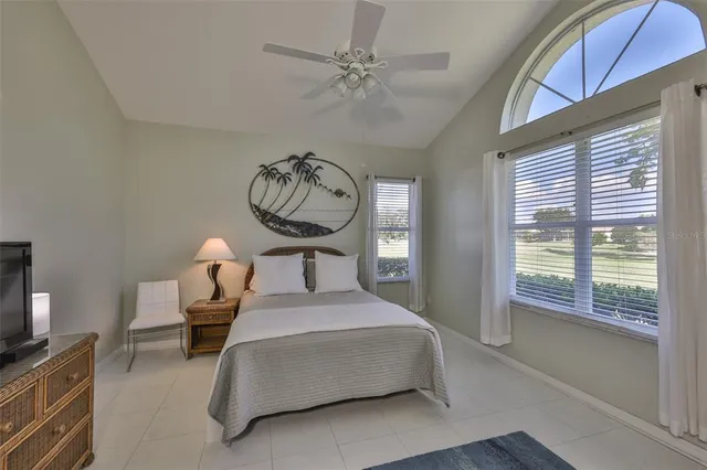 a bedroom with bed and a large window