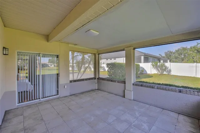 a view of an empty room with a fireplace and a large window