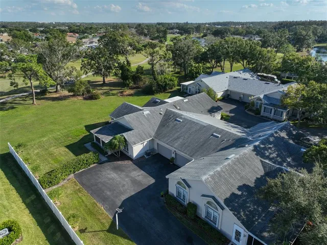 an aerial view of a house with big yard