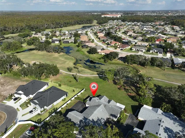 an aerial view of residential houses with outdoor space