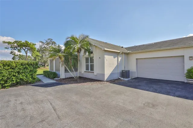 a view of a house with a yard and garage