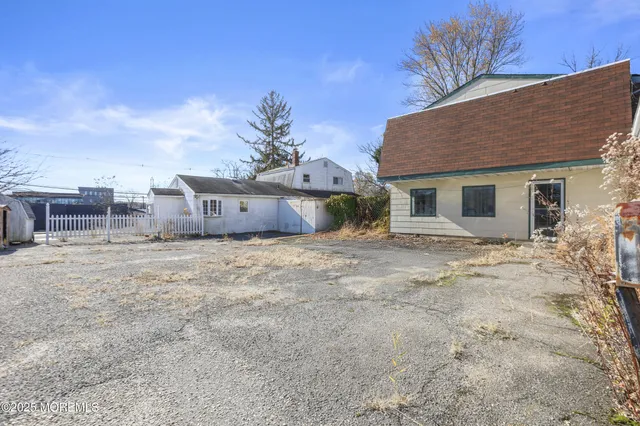 a view of a street with houses in the background