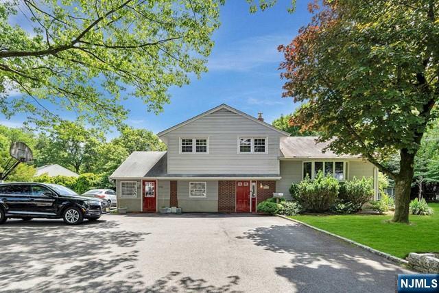 516 Knickerbocker Road Cresskill, NJ 07626 - Photo 2 of 31 a view of house with a garden and pathway