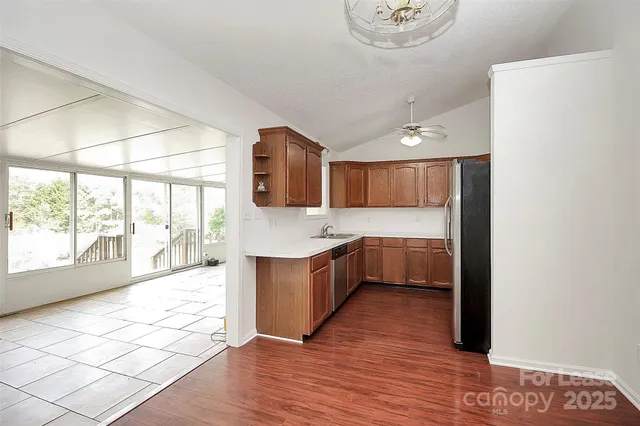a large white kitchen with a large window