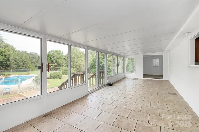 a view of an empty room with a large window