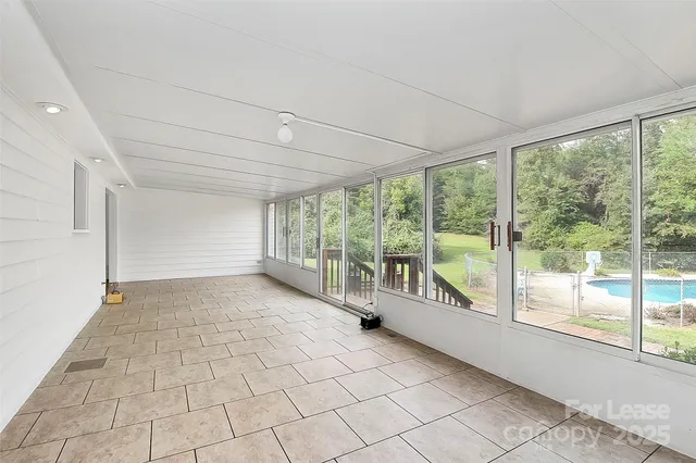 a view of an empty room with a large window