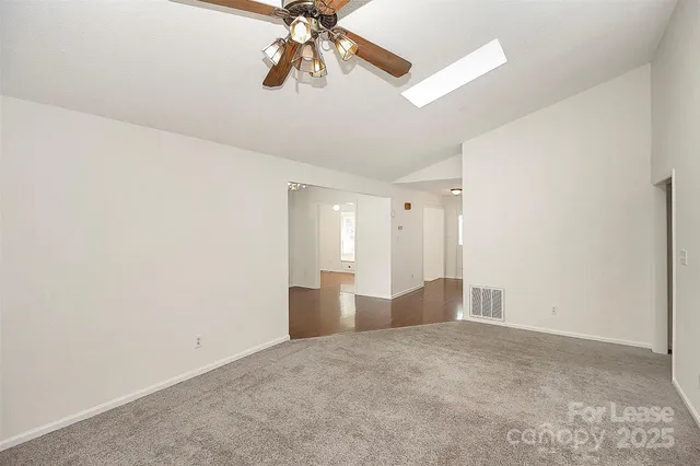 a view of empty room with a fan