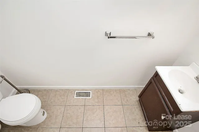 a bathroom with a toilet and a vanity