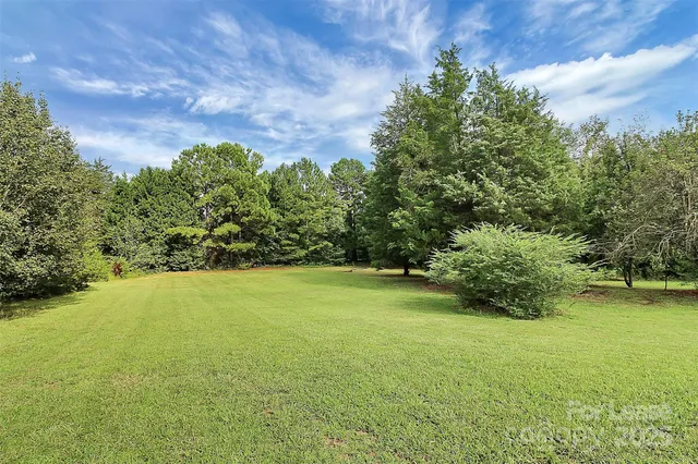 a view of a backyard with sitting area