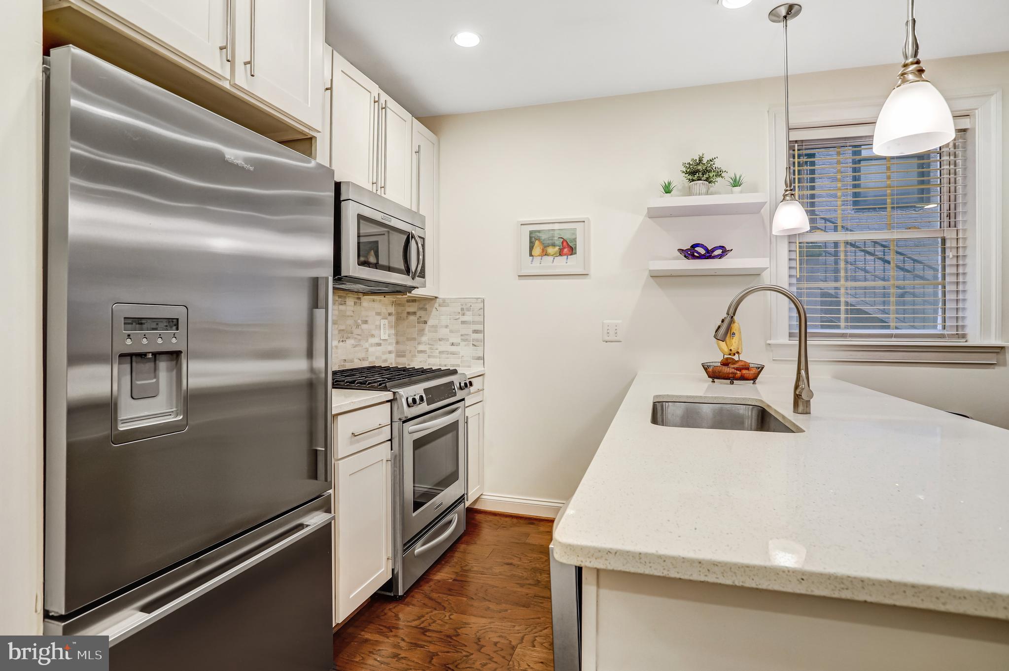 3937 Davis Place Northwest, Unit 1 Washington, DC 20007 - Photo 10 of 20 a kitchen with a refrigerator stove and a sink