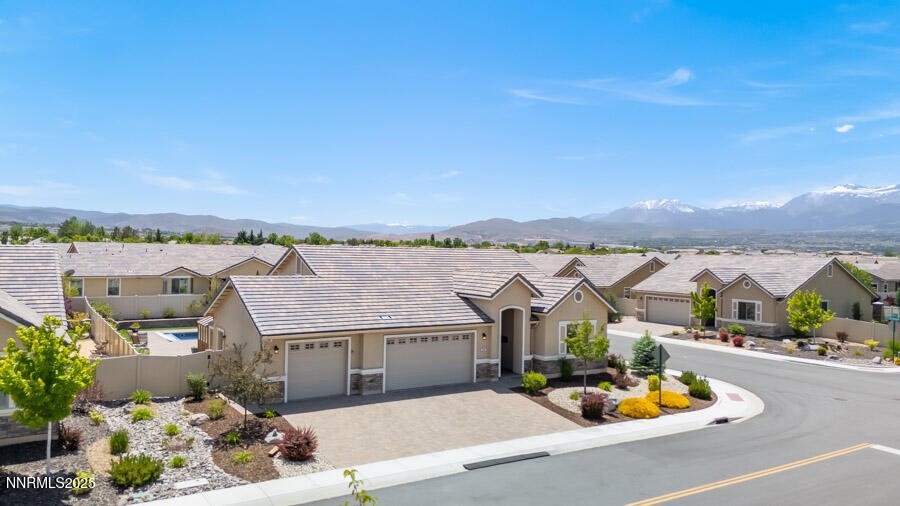 504 Alpine Rose Ct. Reno, NV 89521 - Photo 3 of 27 an aerial view of a house with a garden and mountain view
