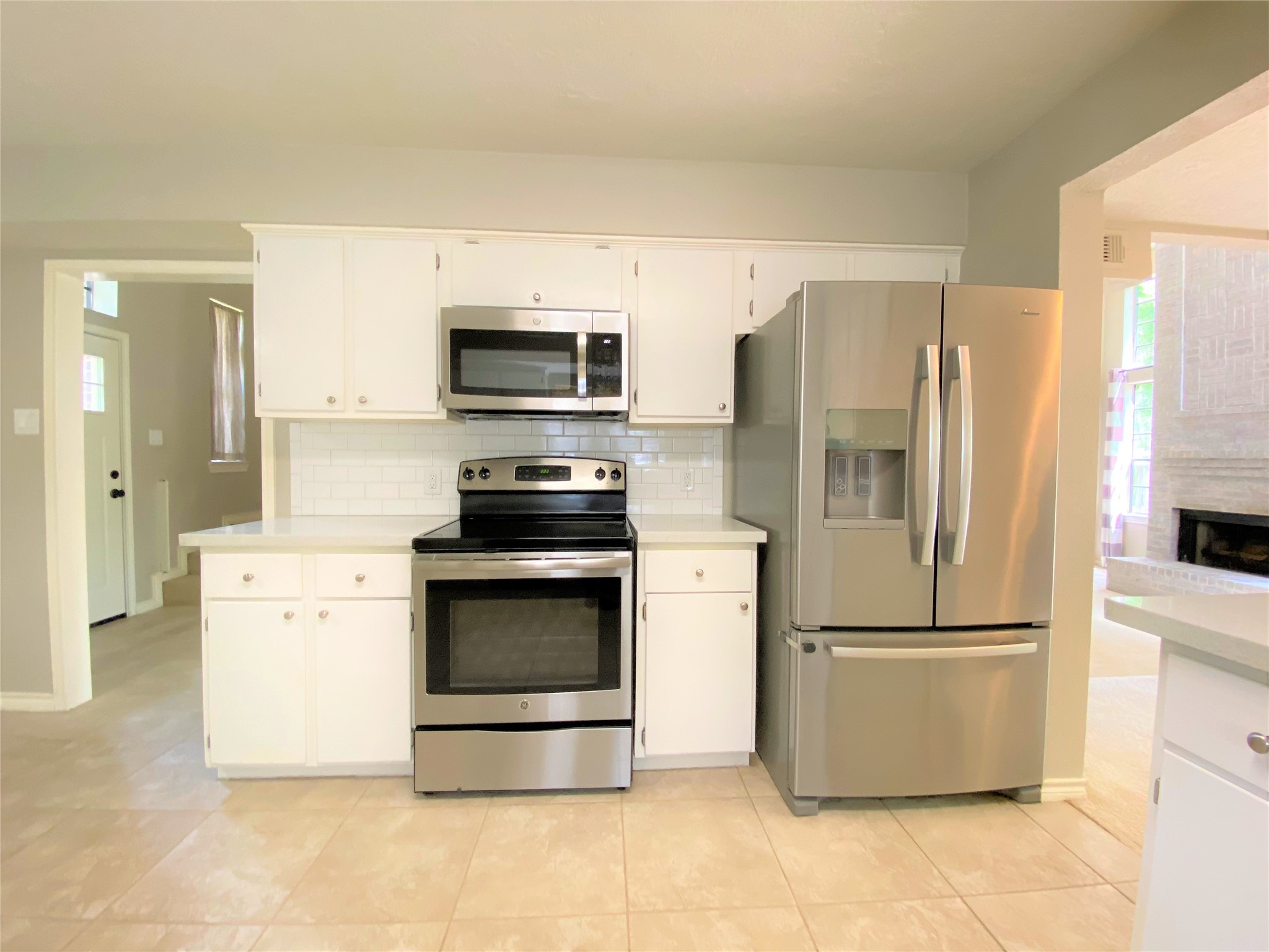 12303 Longfellow Drive Montgomery, TX 77356 - Photo 11 of 26 a kitchen with stainless steel appliances a refrigerator stove and microwave