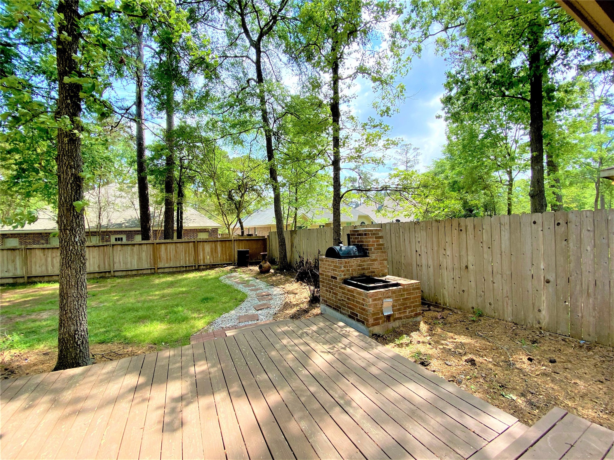12303 Longfellow Drive Montgomery, TX 77356 - Photo 24 of 26 a backyard of a house with table and chairs