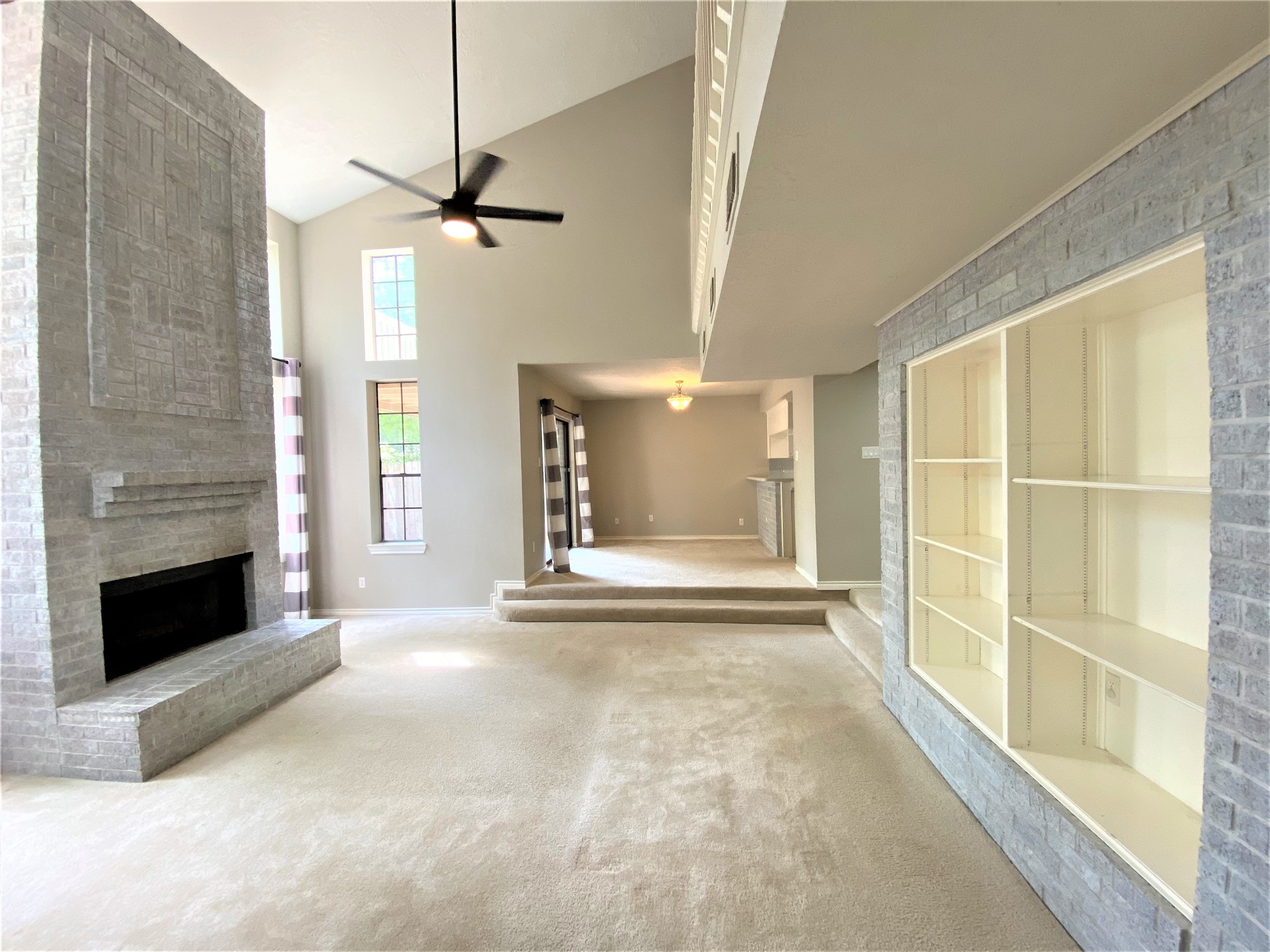 12303 Longfellow Drive Montgomery, TX 77356 - Photo 6 of 26 a view of an empty room with a fireplace and a window