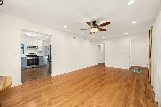 a view of kitchen with sink and refrigerator