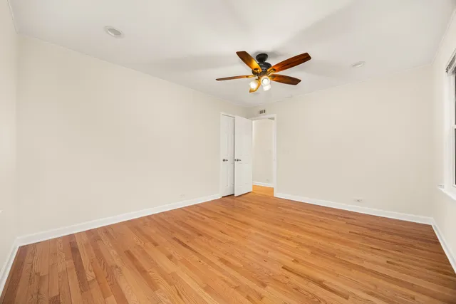 a view of a big room with wooden floor and closet in a room