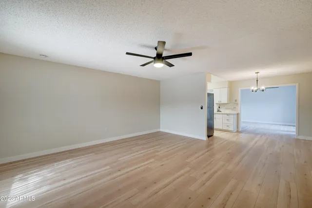 wooden floor in an empty room with a ceiling fan