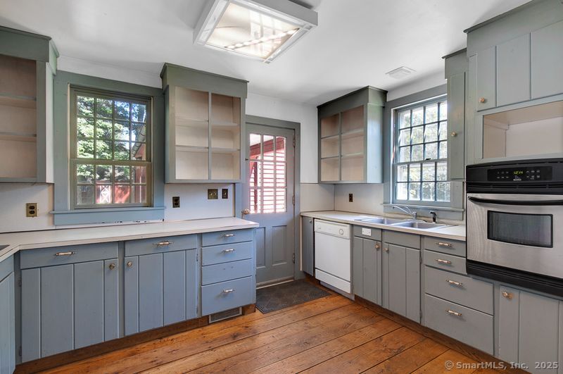 208 Woodcreek Road Bethlehem, CT 06751 - Photo 6 of 29 a kitchen with a sink stove and cabinets