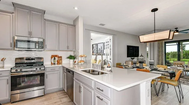 a kitchen with a sink a table and chairs