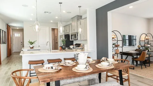 a bedroom with furniture and a large window