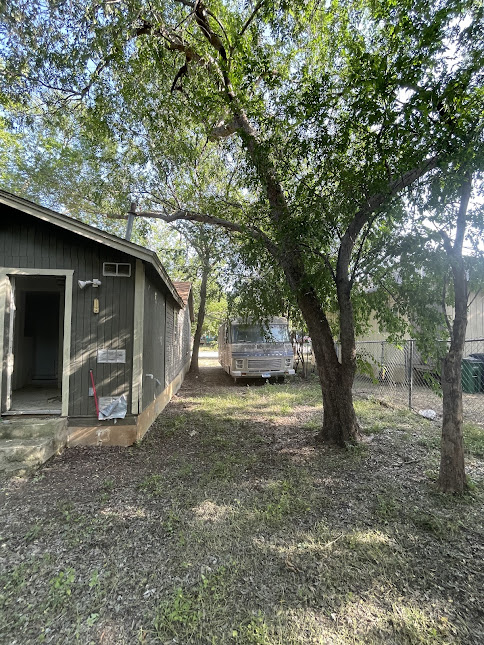 3208 East 16th Street Austin, TX 78721 - Photo 6 of 11 A verdant side yard with mature trees offers ample shade and privacy.