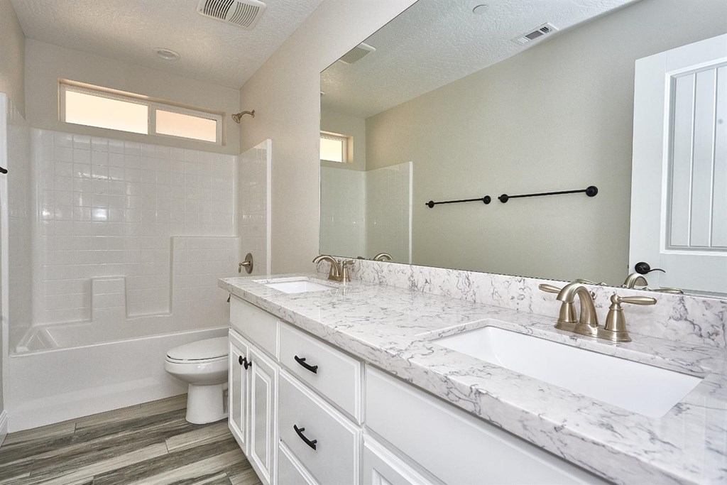 16522 Muni Road Apple Valley, CA 92308 - Photo 42 of 48 a bathroom with a granite countertop sink and a mirror