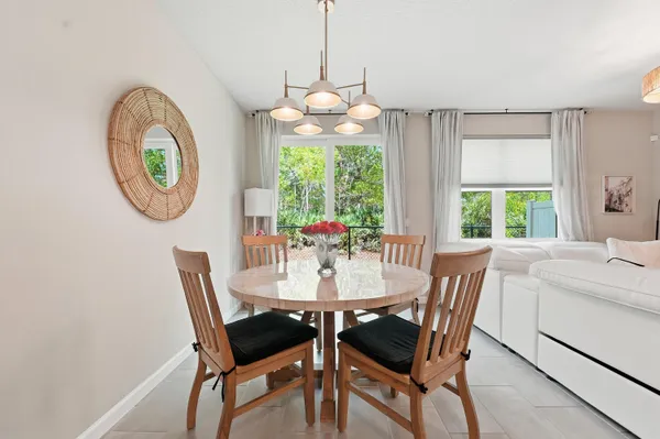 a dining room with furniture a chandelier and a rug
