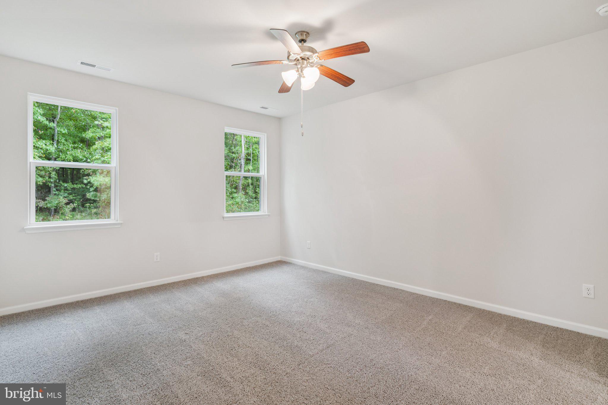 6278 Sterling Way Ruther Glen, VA 22546 - Photo 26 of 32 an empty room with a window and a fan