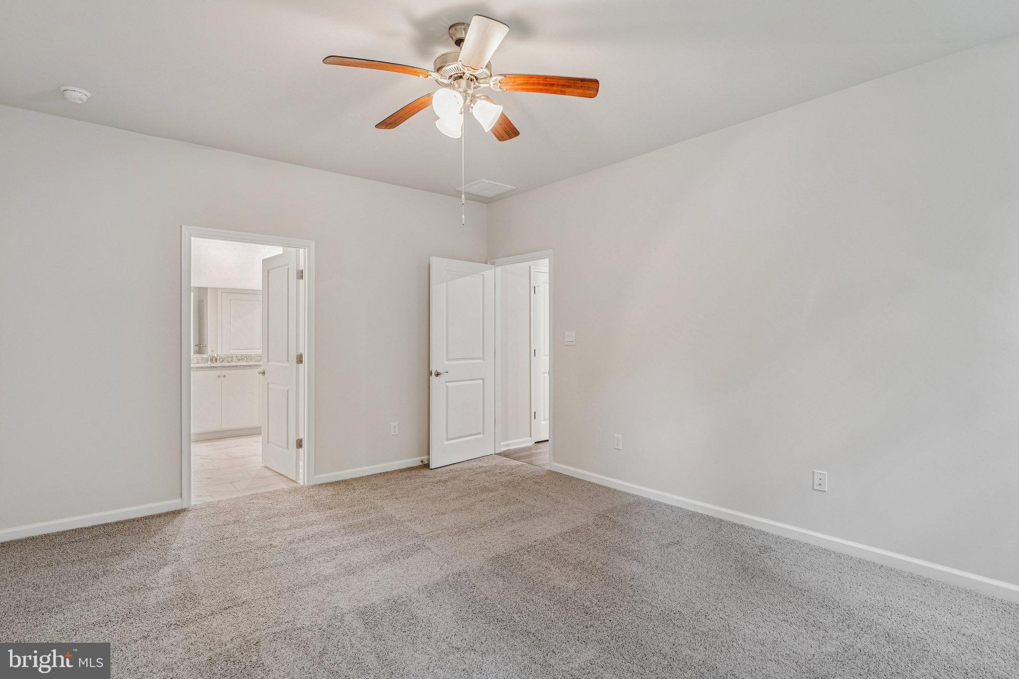 6278 Sterling Way Ruther Glen, VA 22546 - Photo 28 of 32 an empty room with a chandelier fan and windows