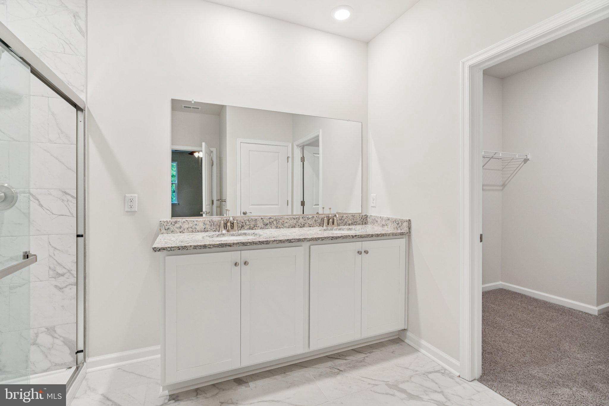 6278 Sterling Way Ruther Glen, VA 22546 - Photo 32 of 32 a bathroom with a granite countertop sink and a mirror