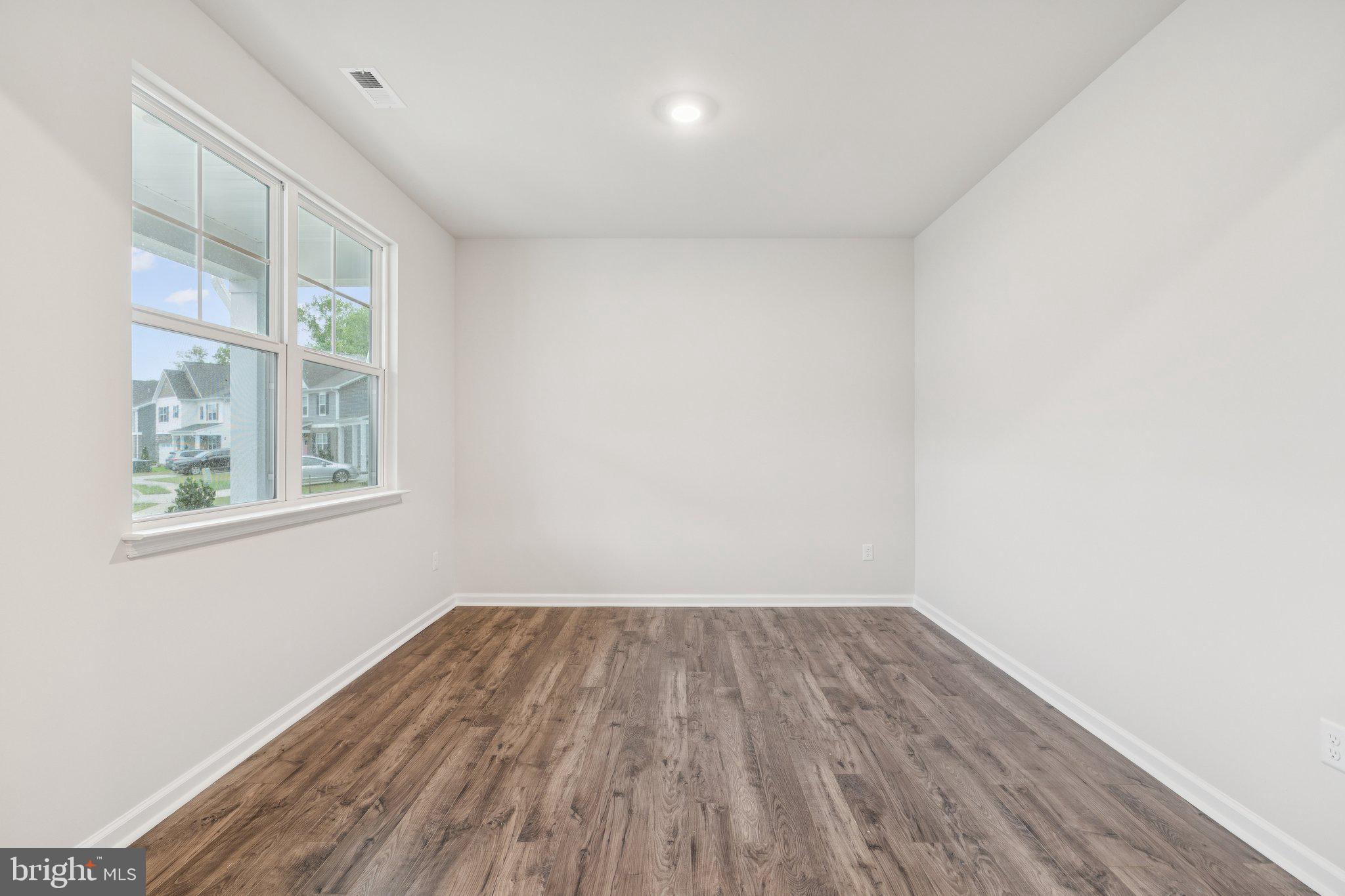 6278 Sterling Way Ruther Glen, VA 22546 - Photo 8 of 32 a view of a room with wooden floor and windows