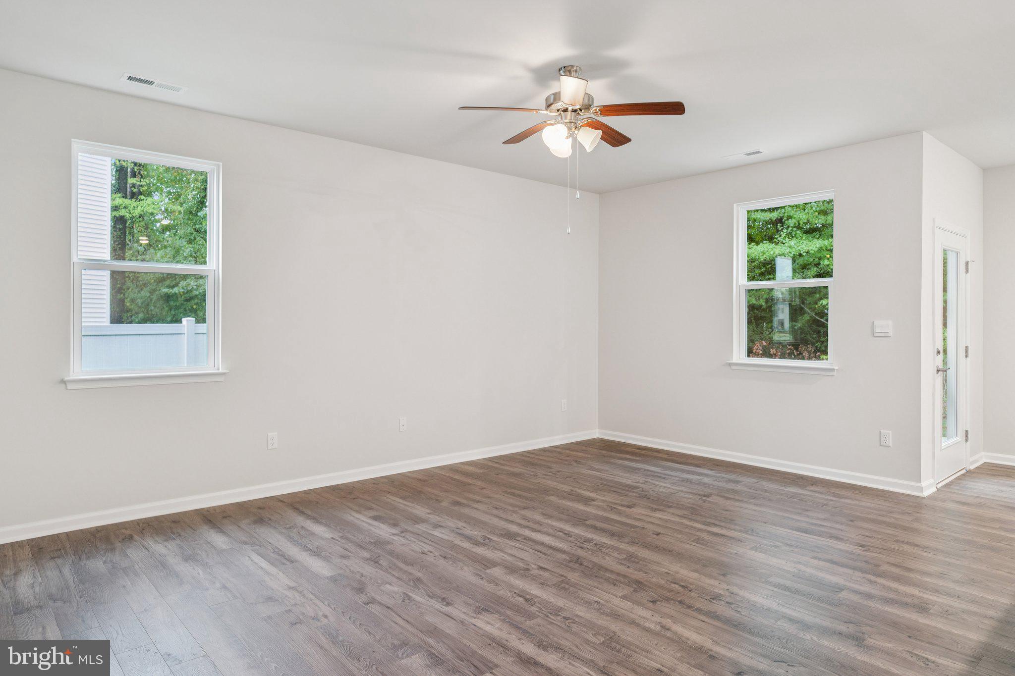 6278 Sterling Way Ruther Glen, VA 22546 - Photo 10 of 32 a view of an empty room with wooden floor and a window