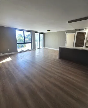 a view of wooden floor and windows in a room