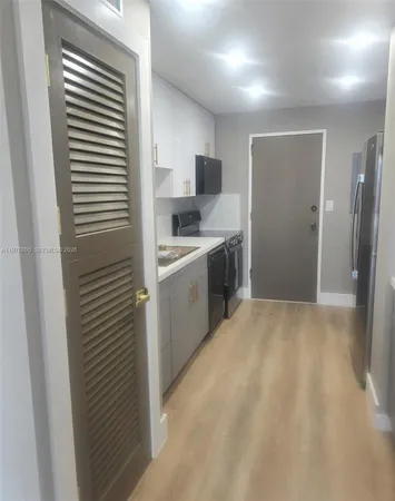 a kitchen with a sink and refrigerator