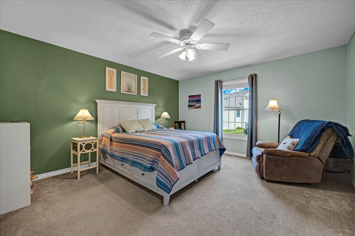 204 Field Drive Normal, IL 61761 - Photo 11 of 34 a bedroom with a bed and a chandelier