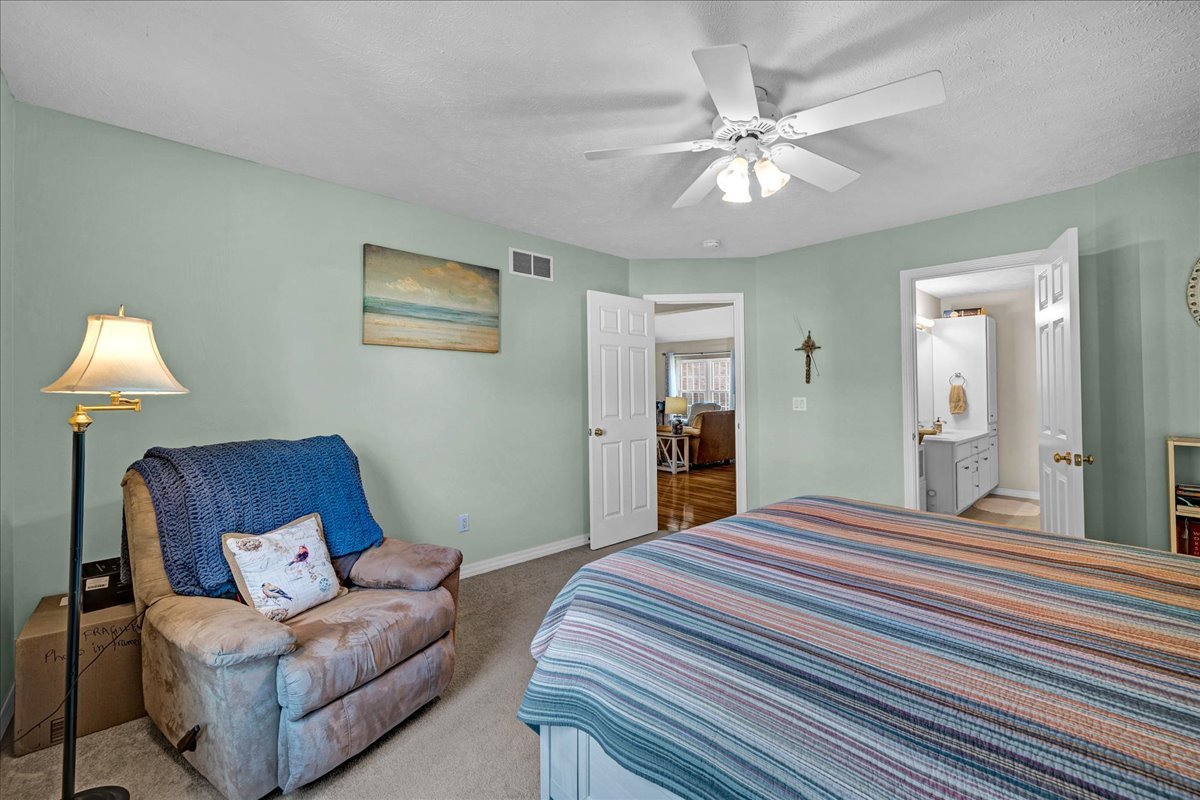 204 Field Drive Normal, IL 61761 - Photo 12 of 34 a bedroom with a large bed and a chandelier