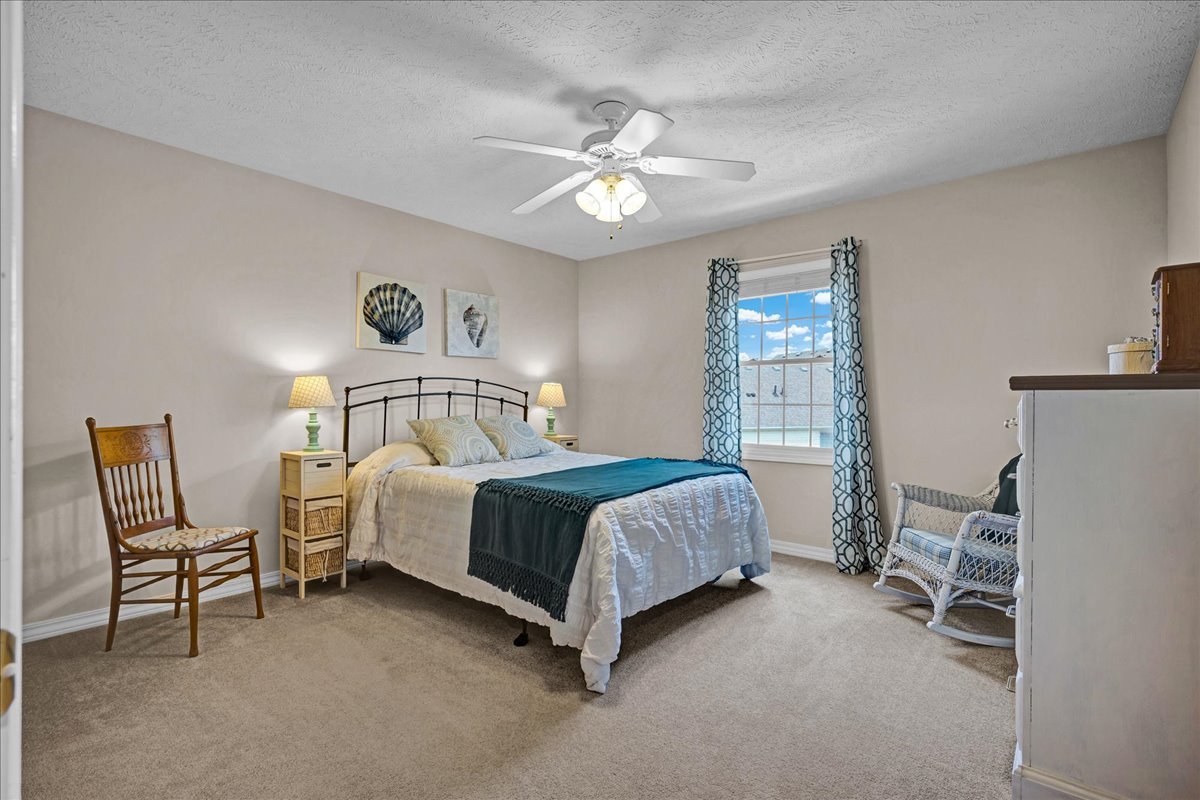 204 Field Drive Normal, IL 61761 - Photo 15 of 34 a spacious bedroom with a bed a chair and a chandelier