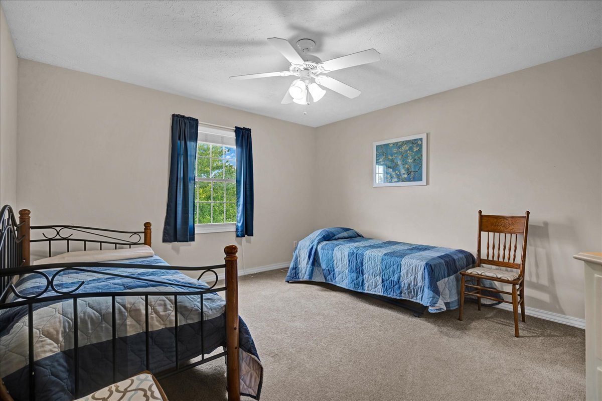 204 Field Drive Normal, IL 61761 - Photo 17 of 34 a bedroom with a bed and a chandelier