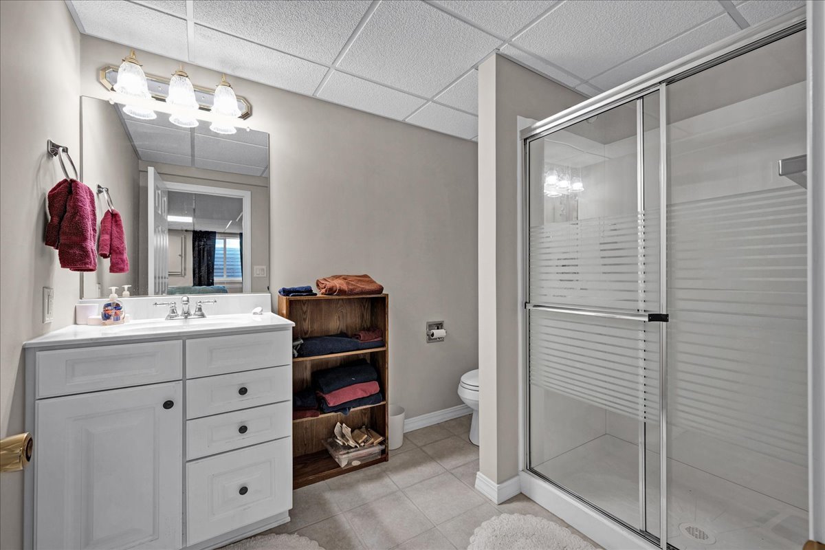 204 Field Drive Normal, IL 61761 - Photo 23 of 34 a bathroom with a sink a vanity a mirror and shower