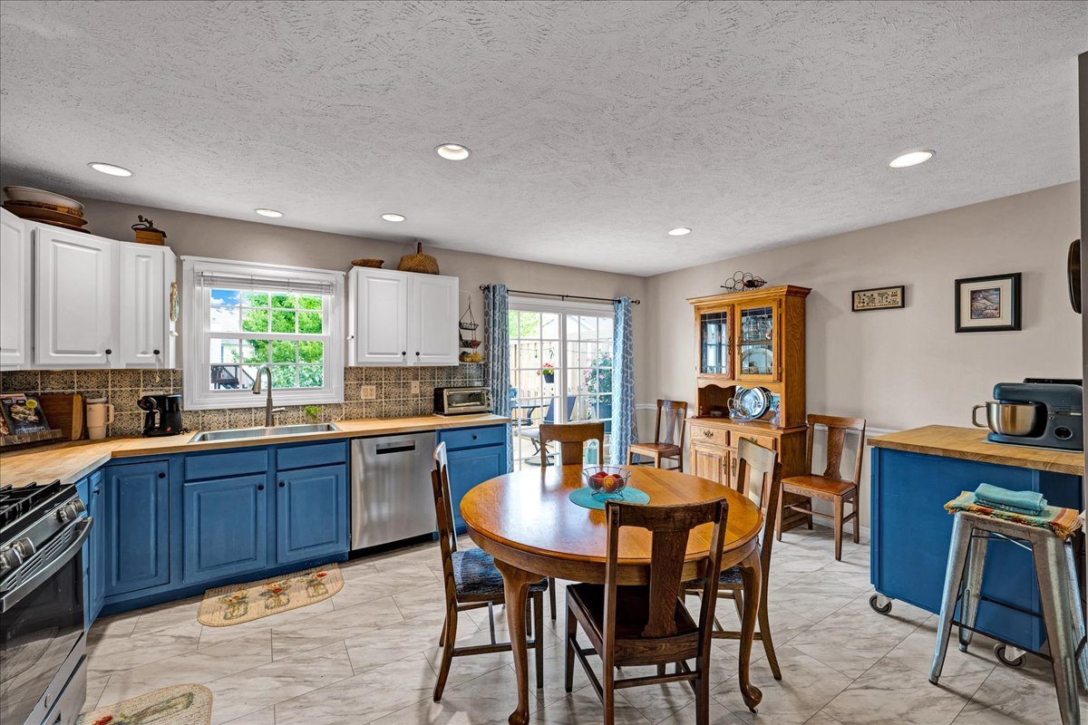 204 Field Drive Normal, IL 61761 - Photo 7 of 34 a dining room with a wooden table and chairs