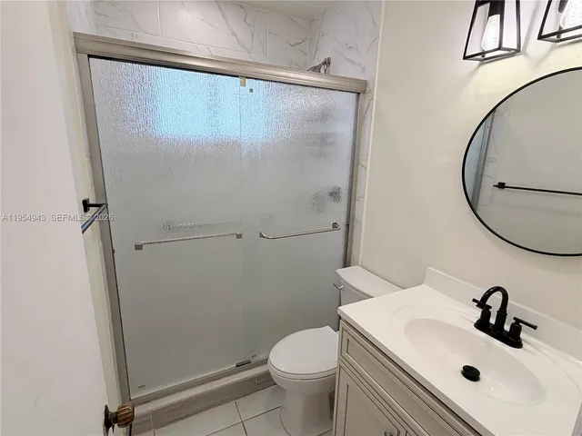 a bathroom with a sink toilet and a mirror