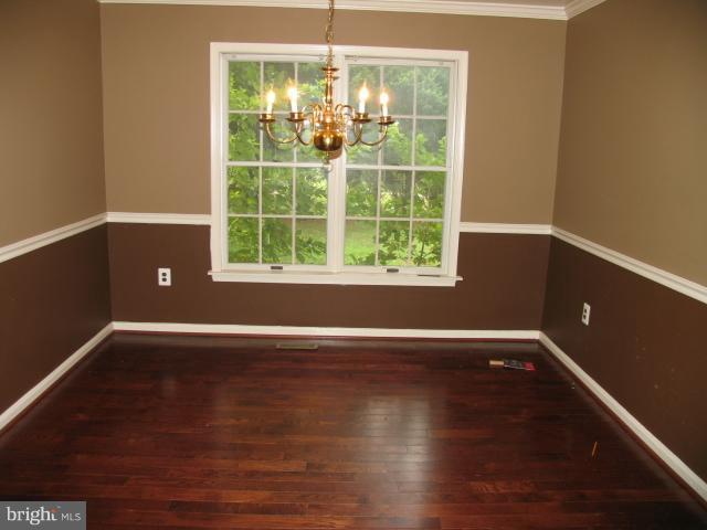 1600 Golf Course Drive Bowie, MD 20721 - Photo 2 of 21 a view of an empty room with wooden floor and a window