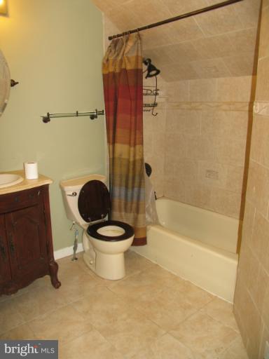 1600 Golf Course Drive Bowie, MD 20721 - Photo 13 of 21 a white toilet sitting next to a bath tub and a shower