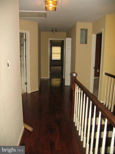 1600 Golf Course Drive Bowie, MD 20721 - Photo 18 of 21 a view of a hallway with wooden floor and a bathroom