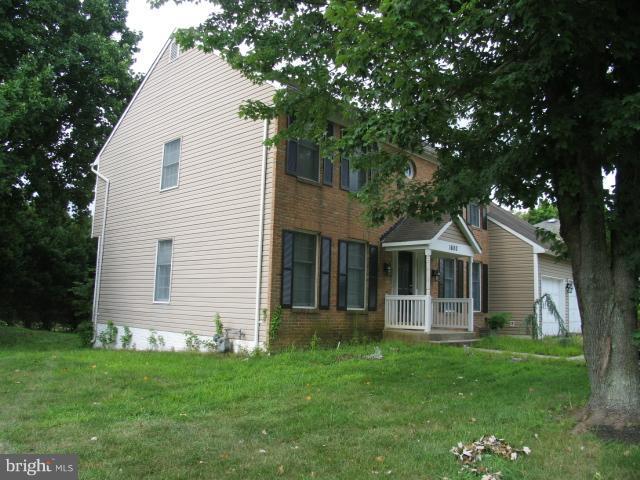 1600 Golf Course Drive Bowie, MD 20721 - Photo 8 of 21 a front view of a house with a garden and yard