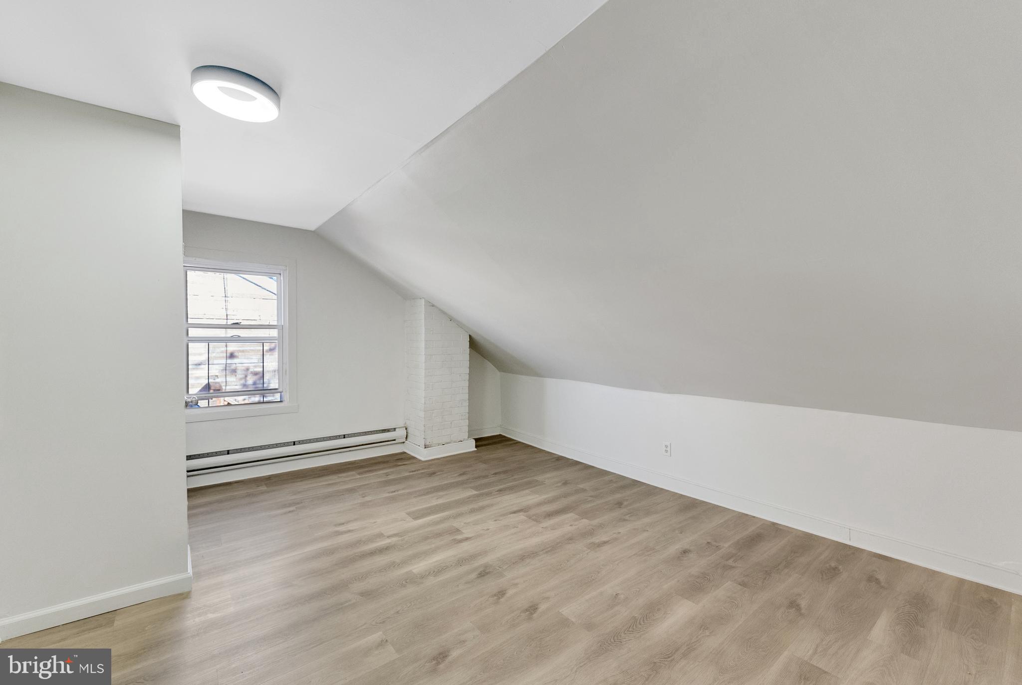 8 Church Street, Unit B Mount Holly, NJ 08060 - Photo 13 of 15 an empty room with wooden floor and windows