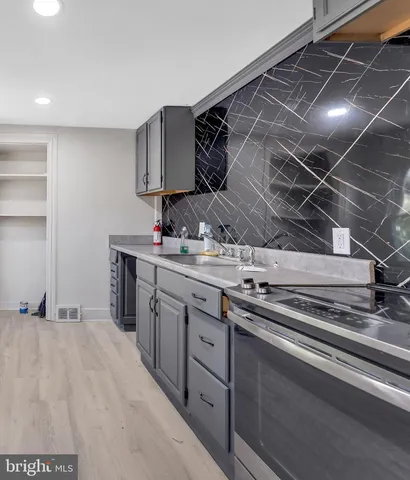 a kitchen with stainless steel appliances a sink and cabinets