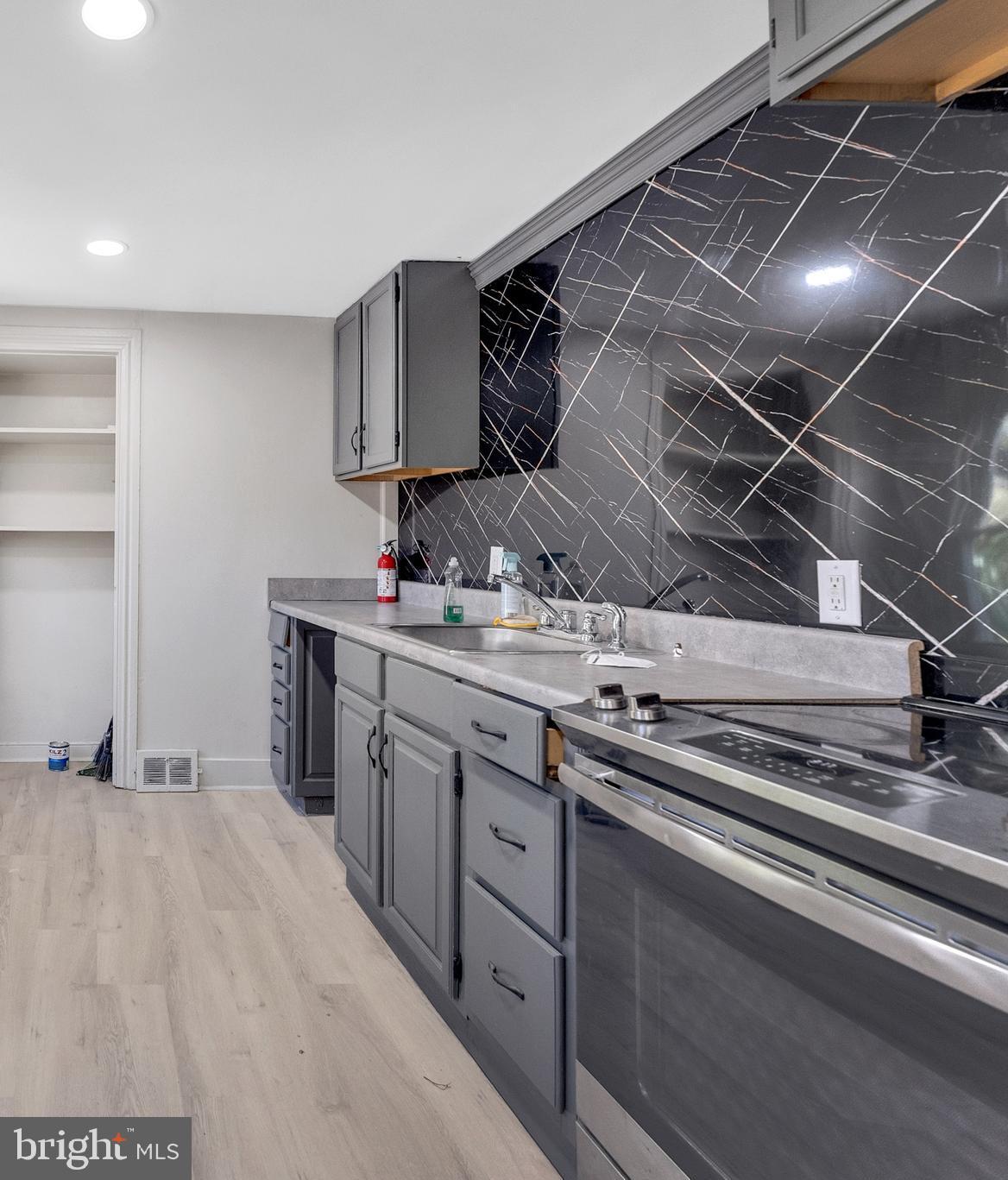 8 Church Street, Unit B Mount Holly, NJ 08060 - Photo 3 of 15 a kitchen with stainless steel appliances a sink and cabinets